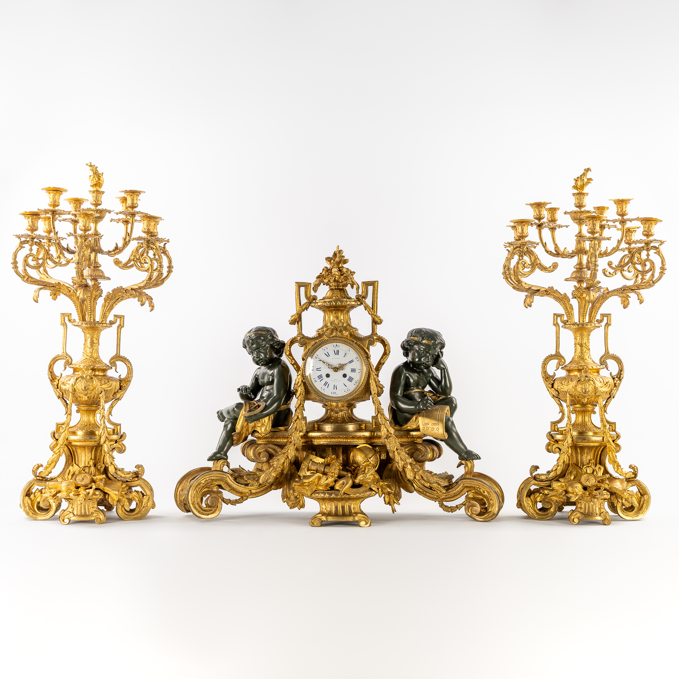 An Exceptional Three-piece Mantel Garniture, Clock and Candelabra, Allegory of Science, Putti, Gilded Bronze, Louis XVI style (L:82 x W:26 x H:66 cm)